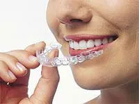 Woman holding clear braces